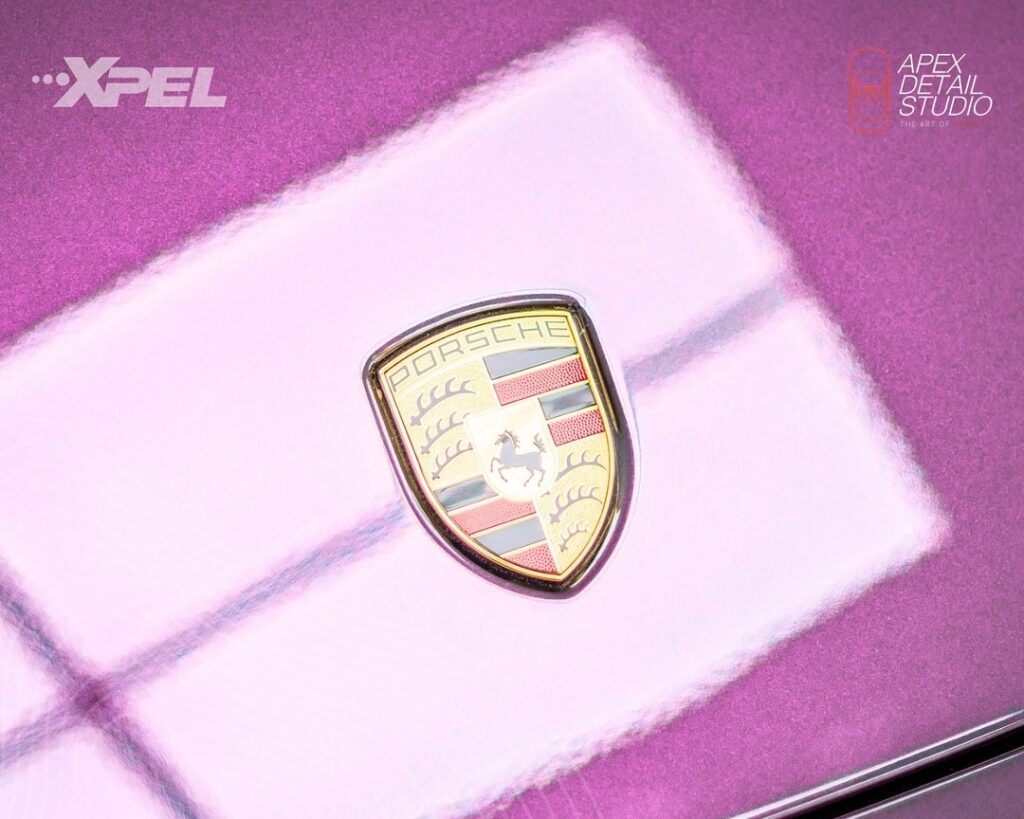 Close-up of XPEL DAP Precut film being applied to a 911 Carrera’s hood for precision paint protection.
