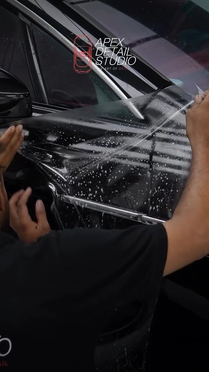 Installer working a PPF edge on the Aston Martin Rapide in Dubai