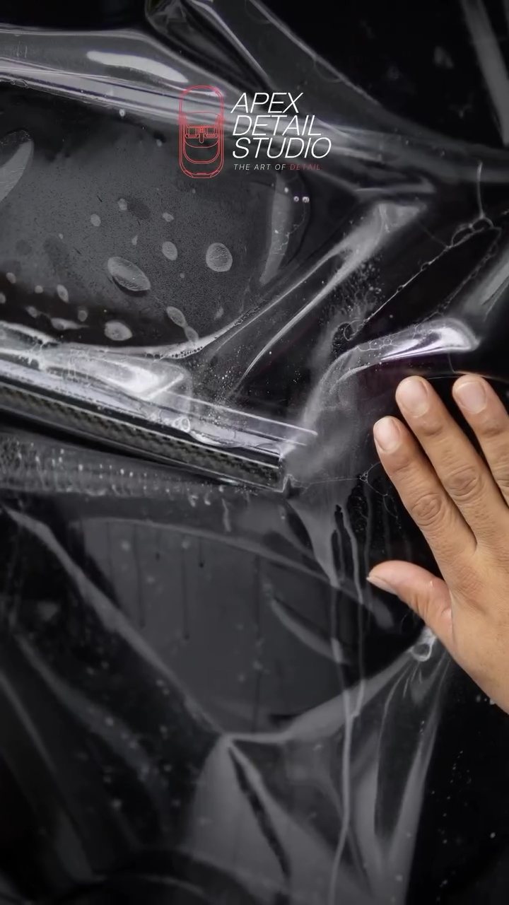 Hands working PPF on the Mercedes-AMG G63 front corner at Apex Detail Studio Dubai