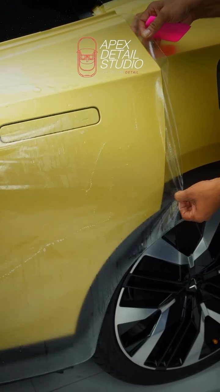 Matte PPF being stretched over the Polestar 4 rear quarter above the wheel