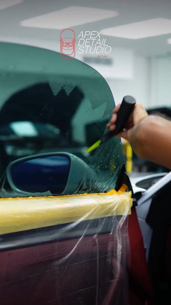 Finishing the tint edge on the Porsche 911 Carrera GTS window at Apex Detail Studio Dubai