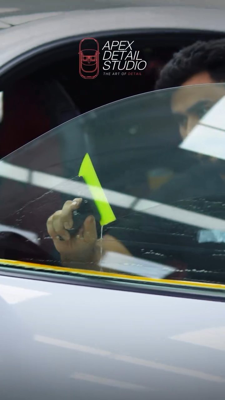 Tint film being positioned on the Porsche 911 Carrera GTS glass