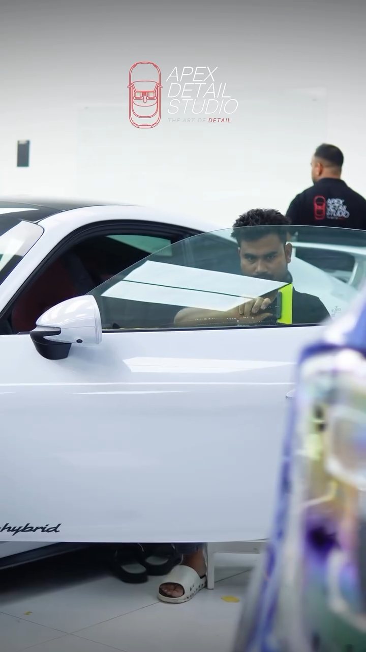 Apex installer fitting window tint from inside the Porsche 911 Carrera GTS in Dubai