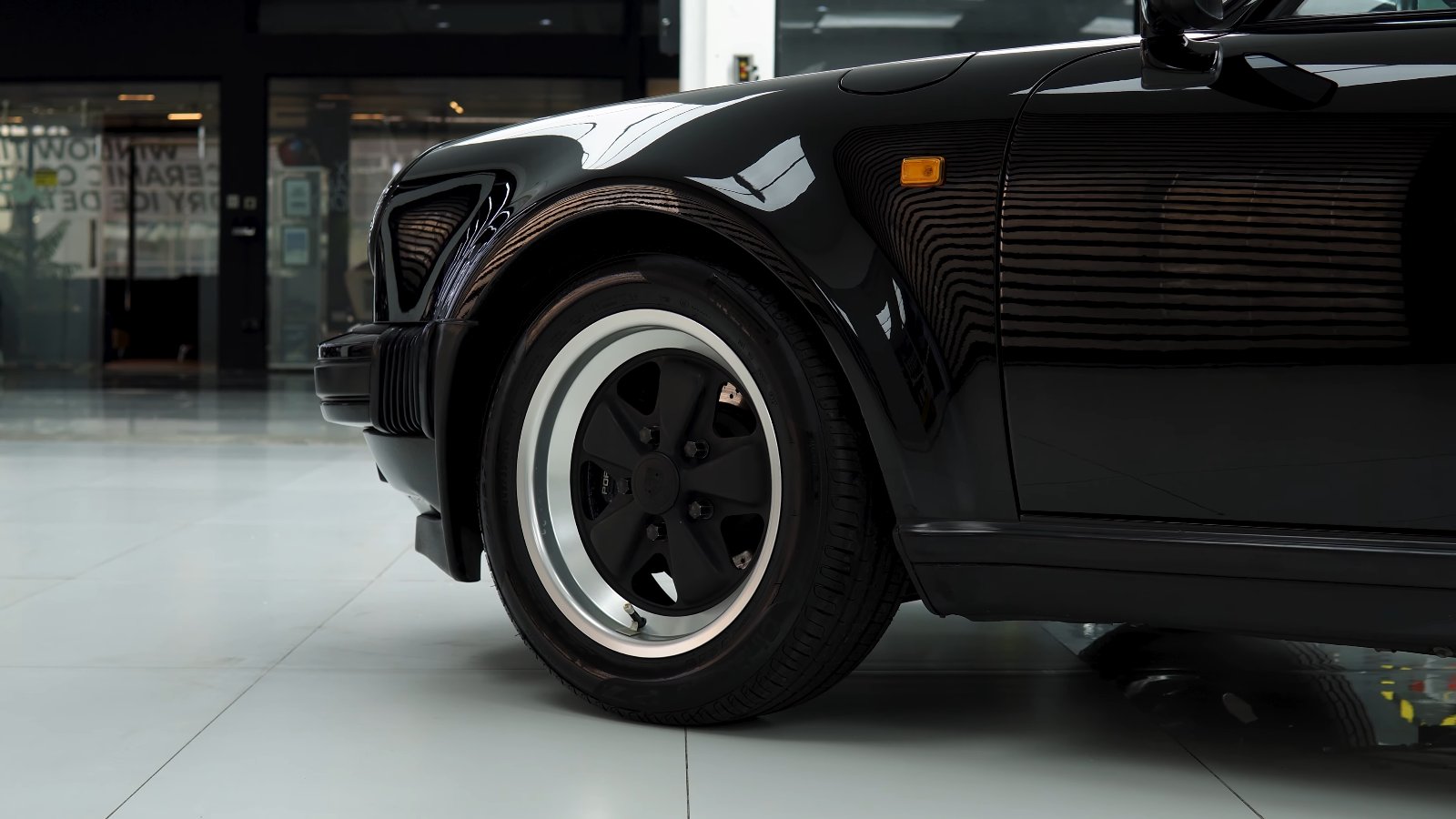 Side view of a black classic Porsche 930 Turbo at Apex Detail Studio