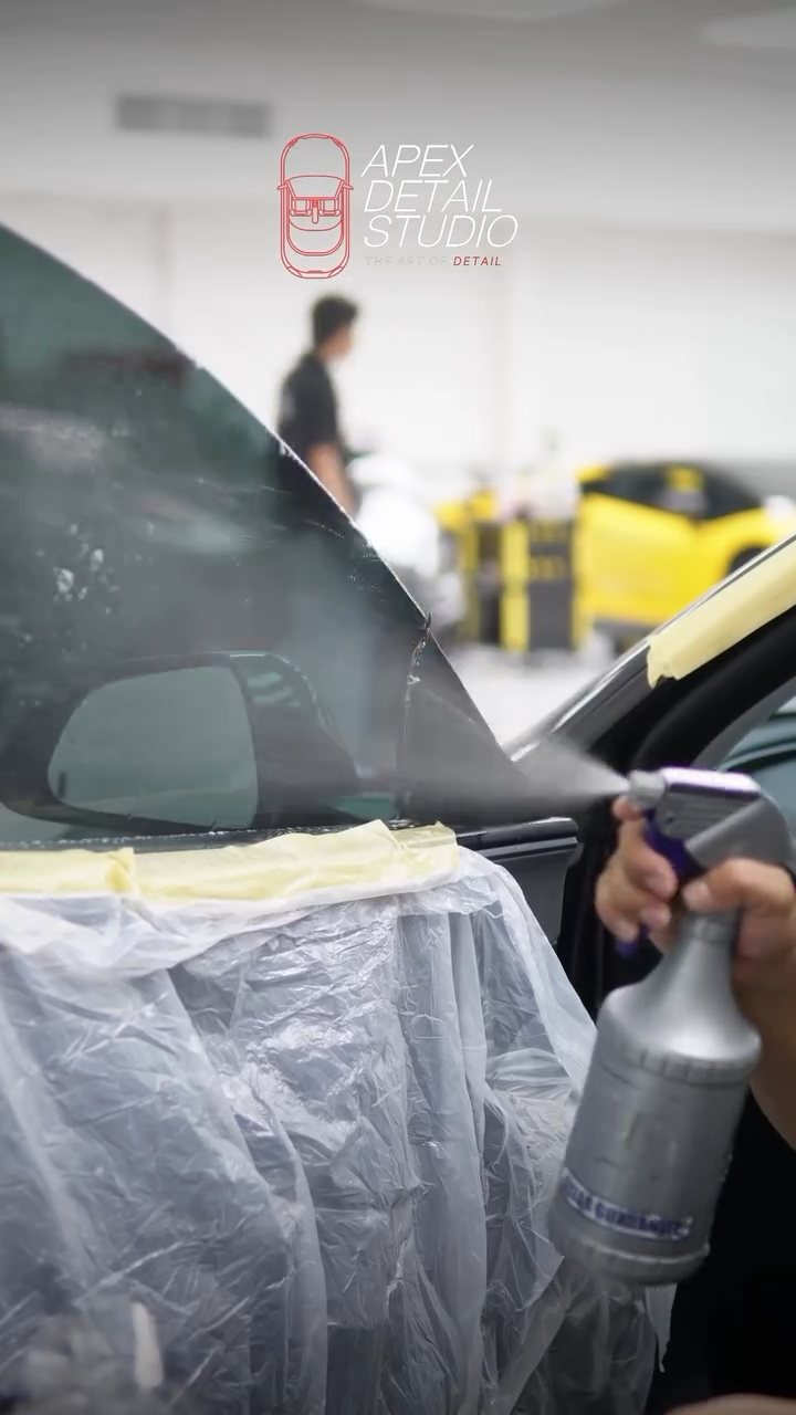 Slip solution sprayed on the Tesla Model 3 window before tint at Apex Detail Studio
