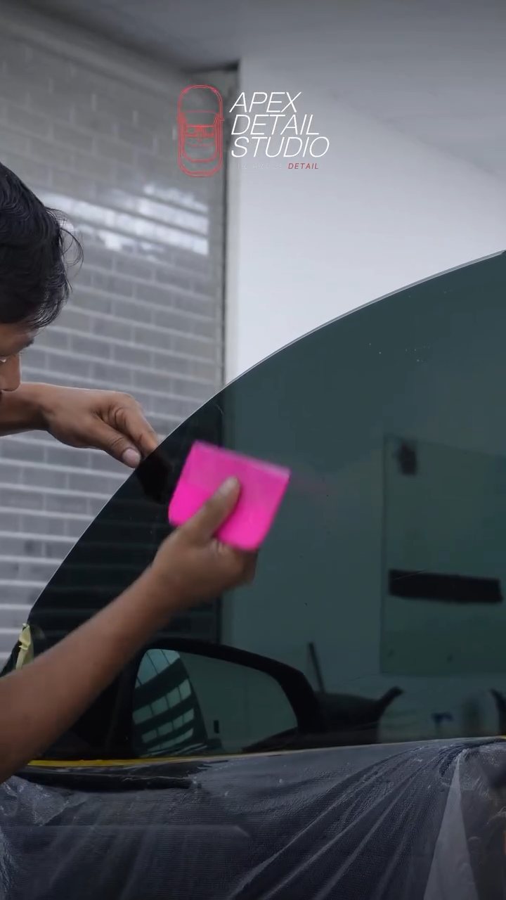 Working the tint edge on the Tesla Model S Plaid at Apex Detail Studio