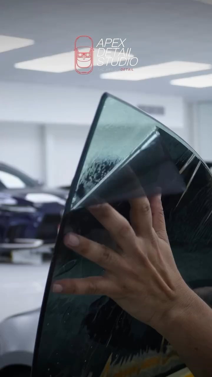 Installer positioning window tint on the Tesla Model S Plaid glass